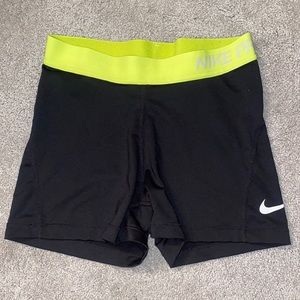 Black and neon yellow Nike Pro spandex shorts